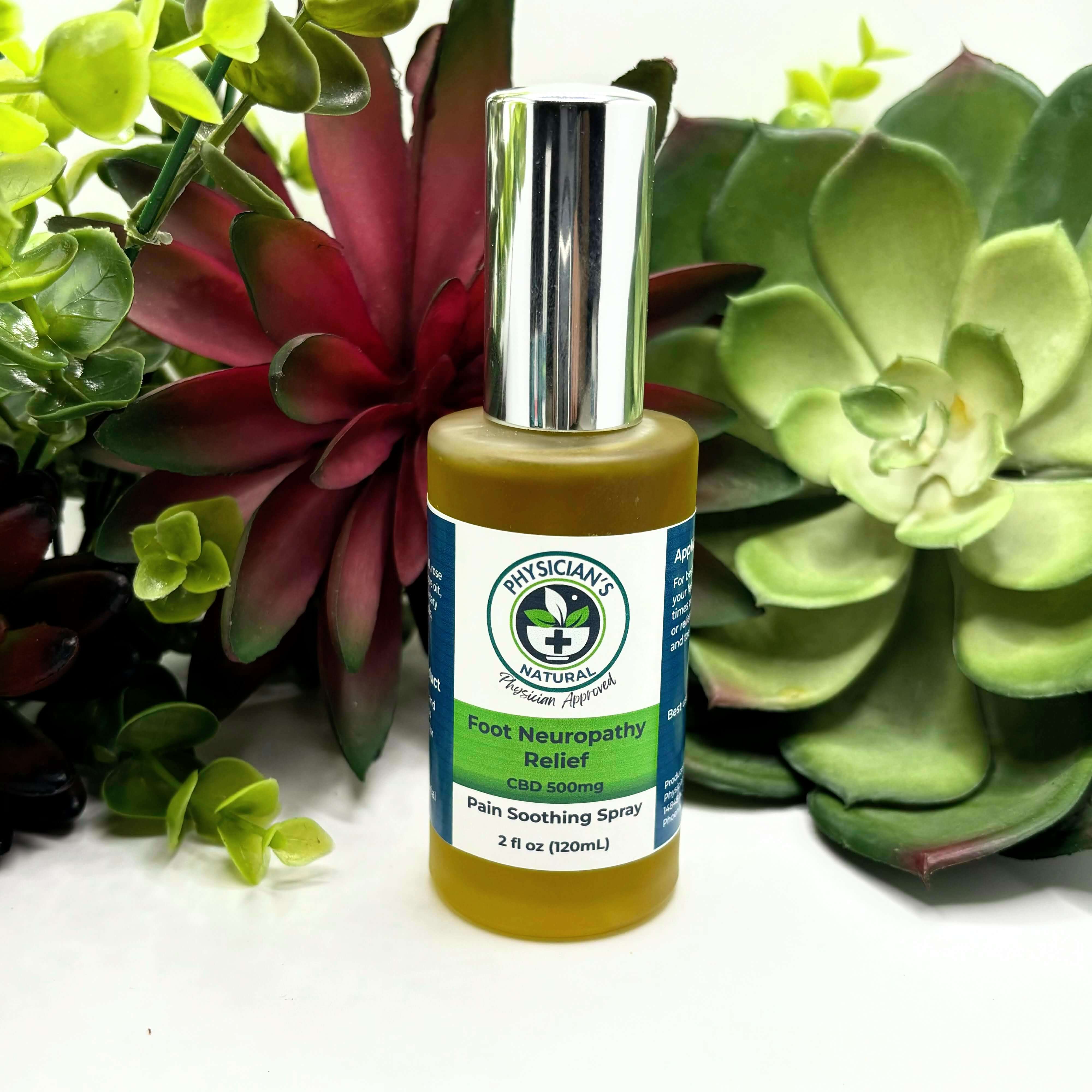 Frosted bottle with silver top, green and blue label, 500 mg CBD Foot Neuropathy Relief Pain Soothing Spray, surrounded by succulent plants.